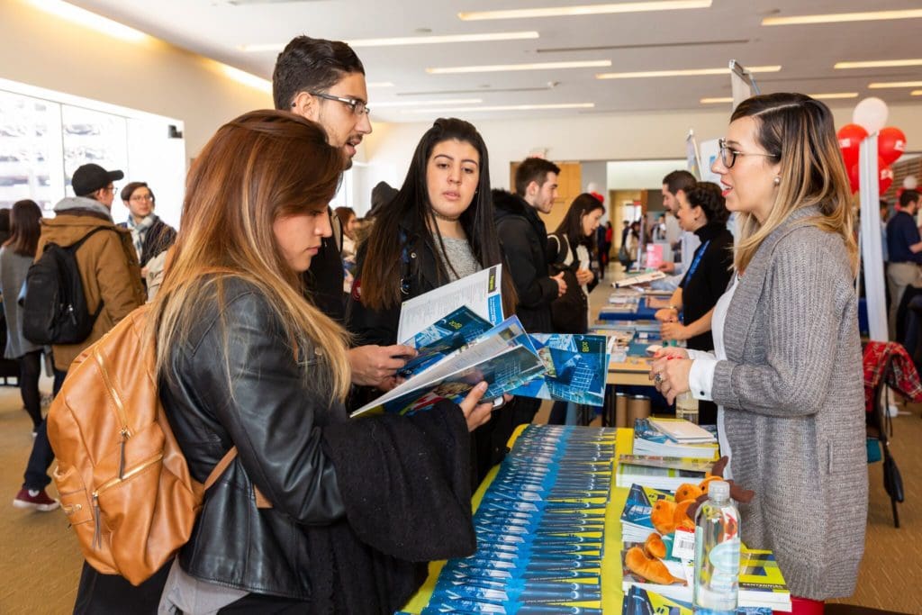 Students talking to a school representative at the ILAC Higher Education Fair in Toronto