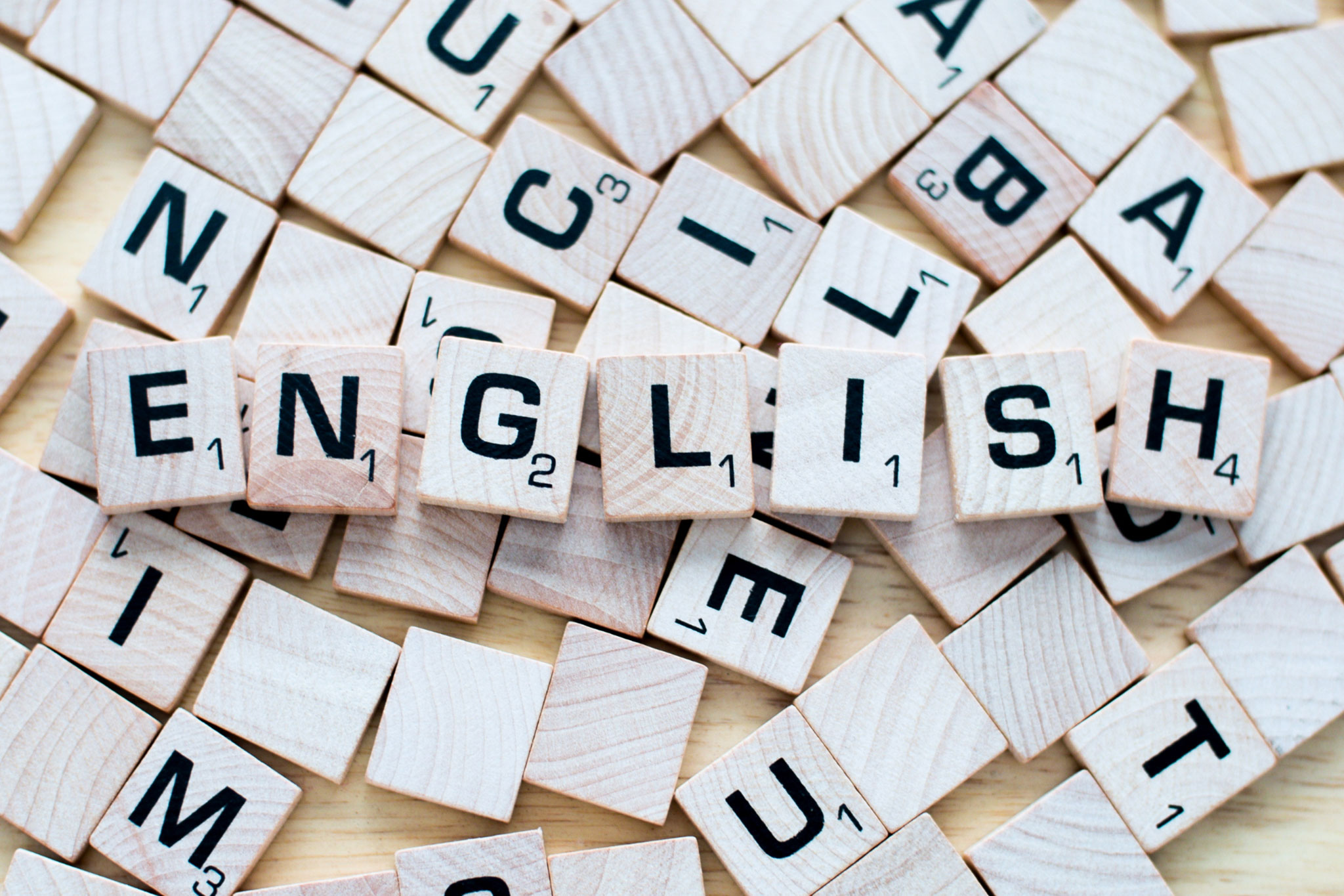 Wooden scrabble tiles spelling out the word English