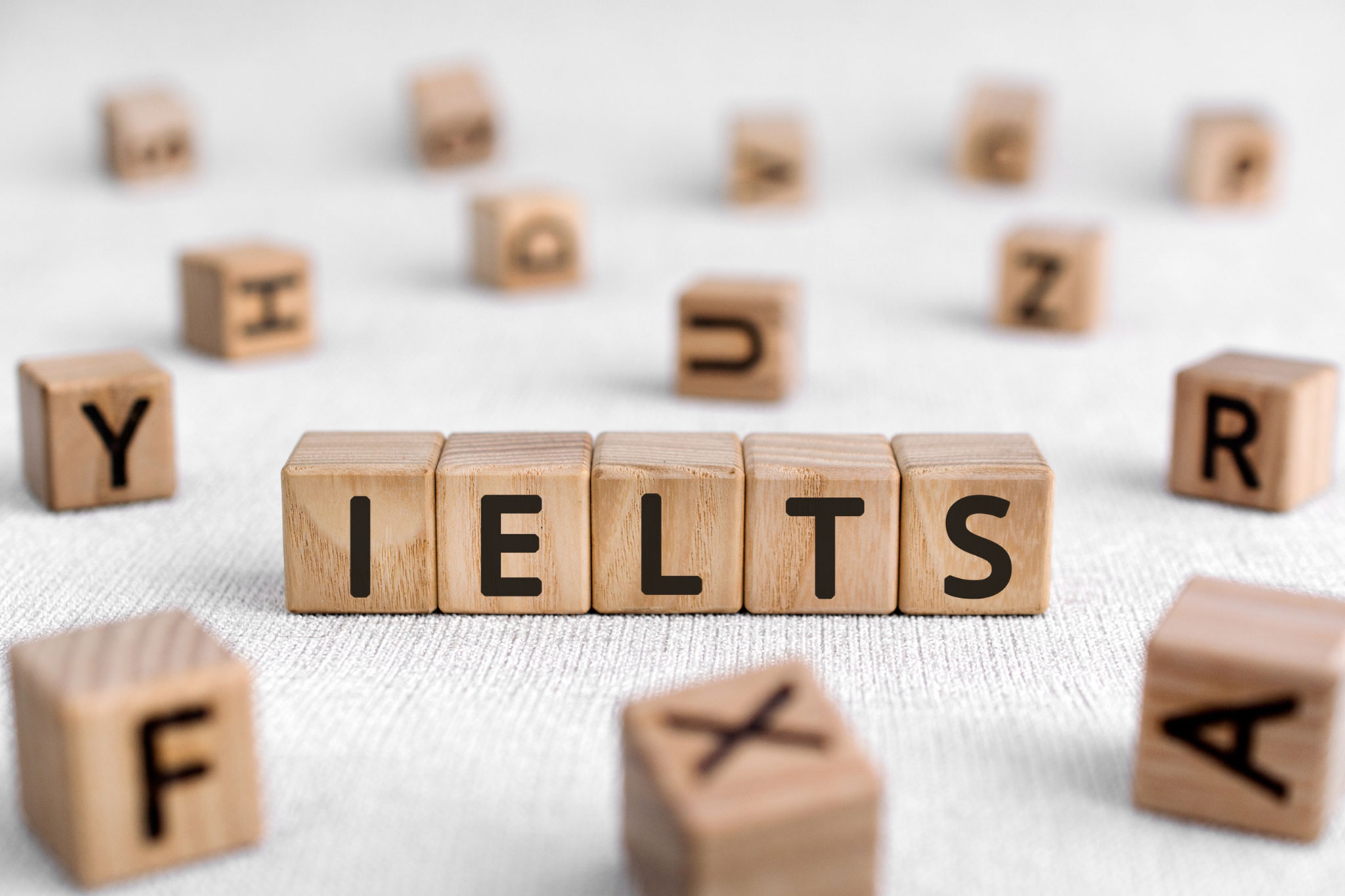 Wooden blocks with letters forming the term IELTS