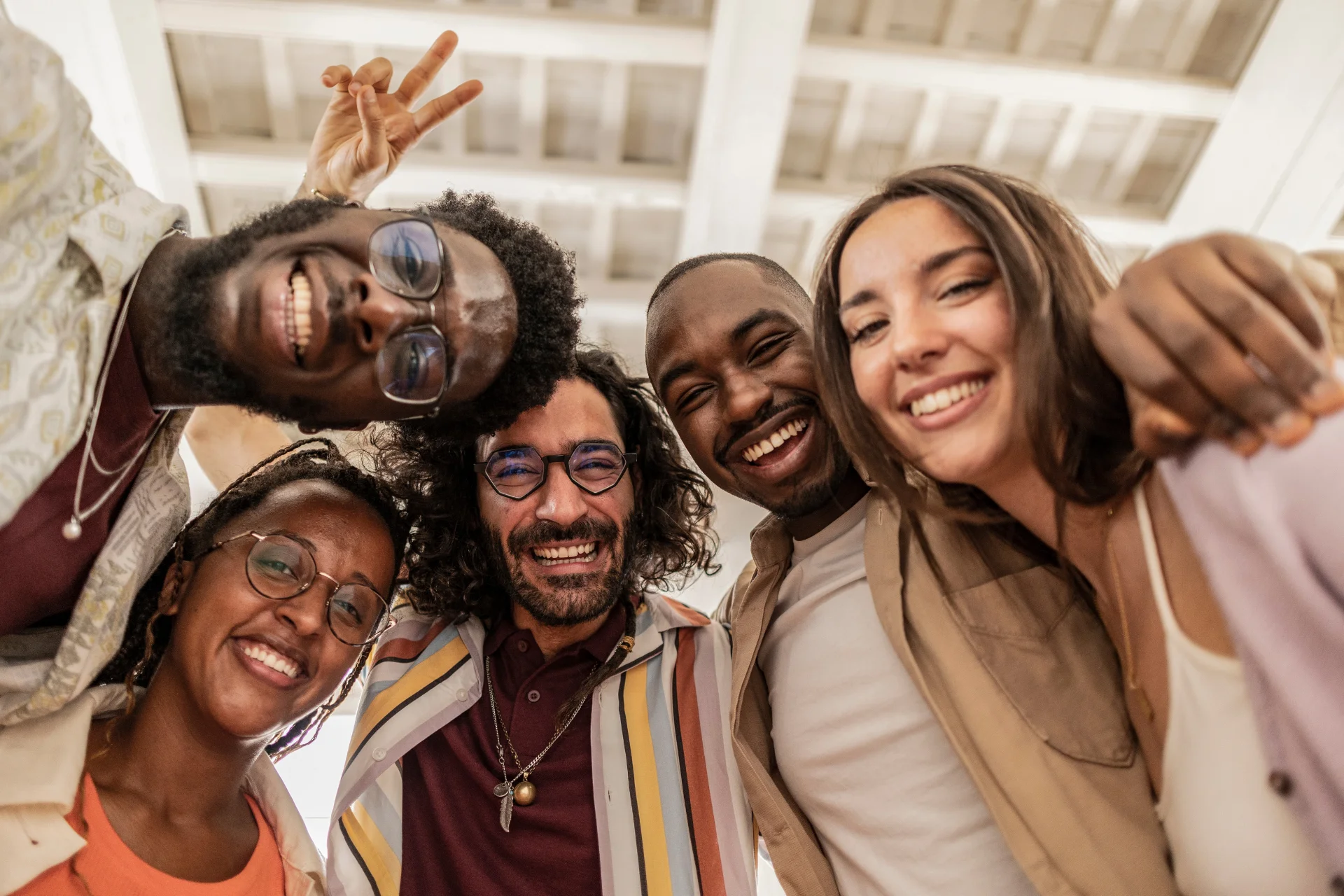 Five young adults pose for a photo together