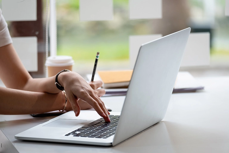Student reviewing CELPIP score chart breakdown on a laptop during test preparation.