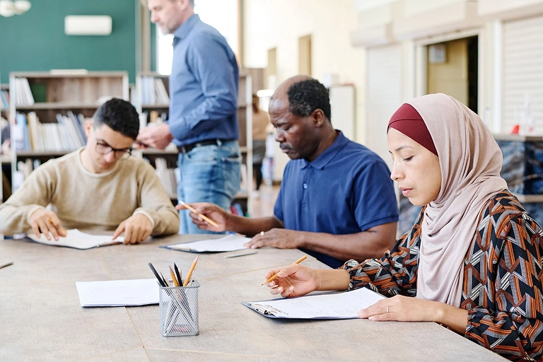 Some adults taking a sample language test