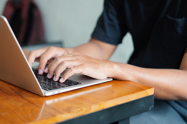 A person typing on a laptop